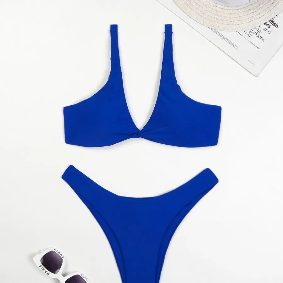 Fashion-forward women's solid colour swimwear set featuring a low waist bikini bottom and triangle bra cups, perfect for a luxurious beach getaway.