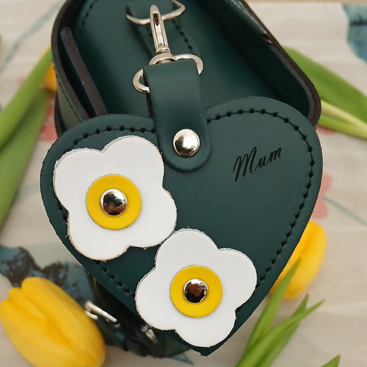 Close-up detail of the Luxury Love Heart Bag Charm, showcasing exquisite flower appliqués and 'Made in England' embossed logo, ideal for gifting or personal use.