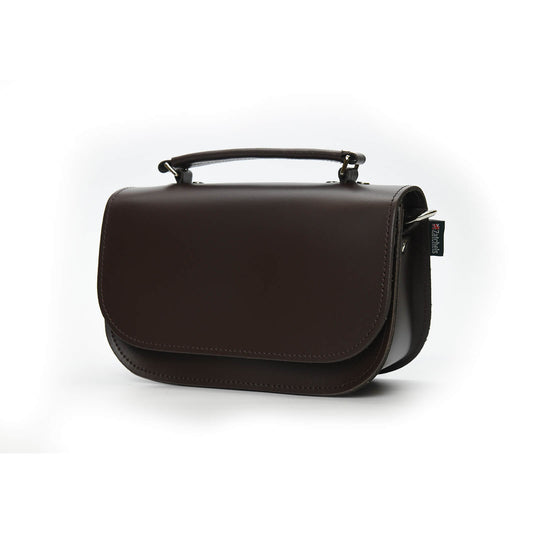 Stylish display of the Aura Luxury Handmade Dark Brown Leather Handbag featuring a detachable strap, magnetic closure, and spacious interior, perfect for modern British elegance in any setting.