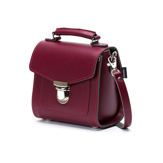 Versatile Handmade Oxblood Leather Sugarcube Handbag displayed in crossbody and clutch styles, highlighting its adjustable strap feature.