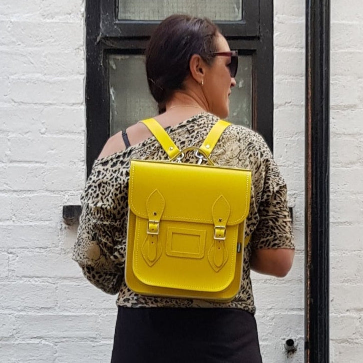 Stylish model wearing the Premium Handmade Leather City Backpack as a shoulder bag, emphasising its versatility and contemporary appeal for everyday use.