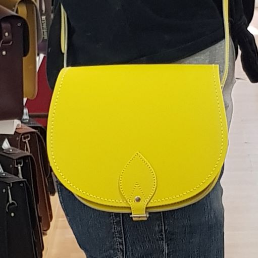 Interior view of the handmade pastel daffodil yellow leather saddle bag by Zatchels, featuring spacious compartment for essential organisation and chic styling.