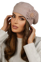 A woman elegantly wearing a luxury beret with a floral embellishment, showcasing styles from the Luxury Berets Collection, perfect for adding sophistication to any outfit.