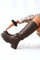 Stylish over-the-knee women's boots showcased in a luxurious pose, perfect for elevating your outfit this season.