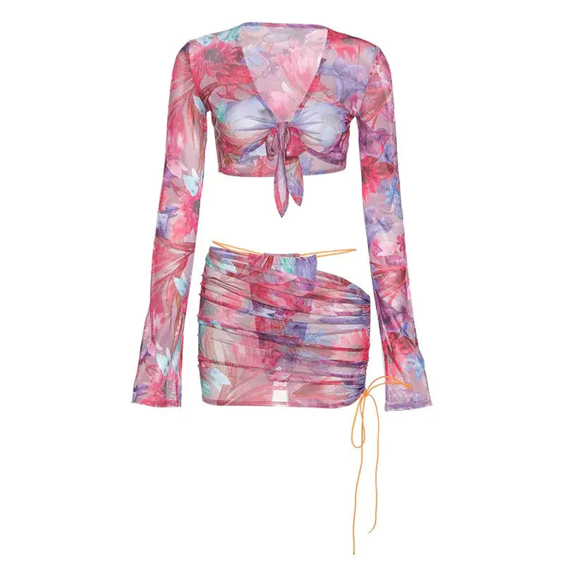Luxury floral print clothing sets featuring a long-sleeve knotted crop top and a stylish ruched mini skirt, perfect for chic summer occasions.