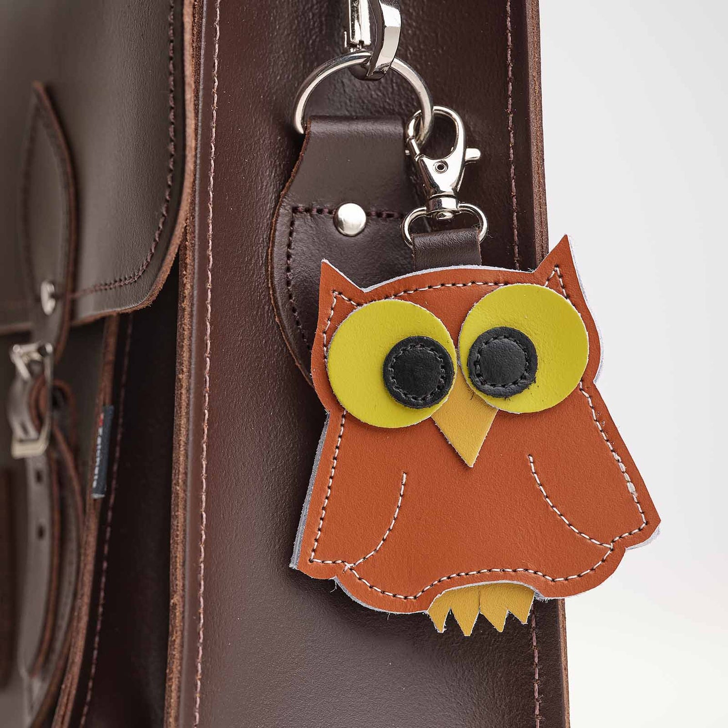Luxury hand-crafted burnt orange owl bag charm made from genuine leather, measuring 90 x 90 mm, perfect for adding elegance to your collection of charms.