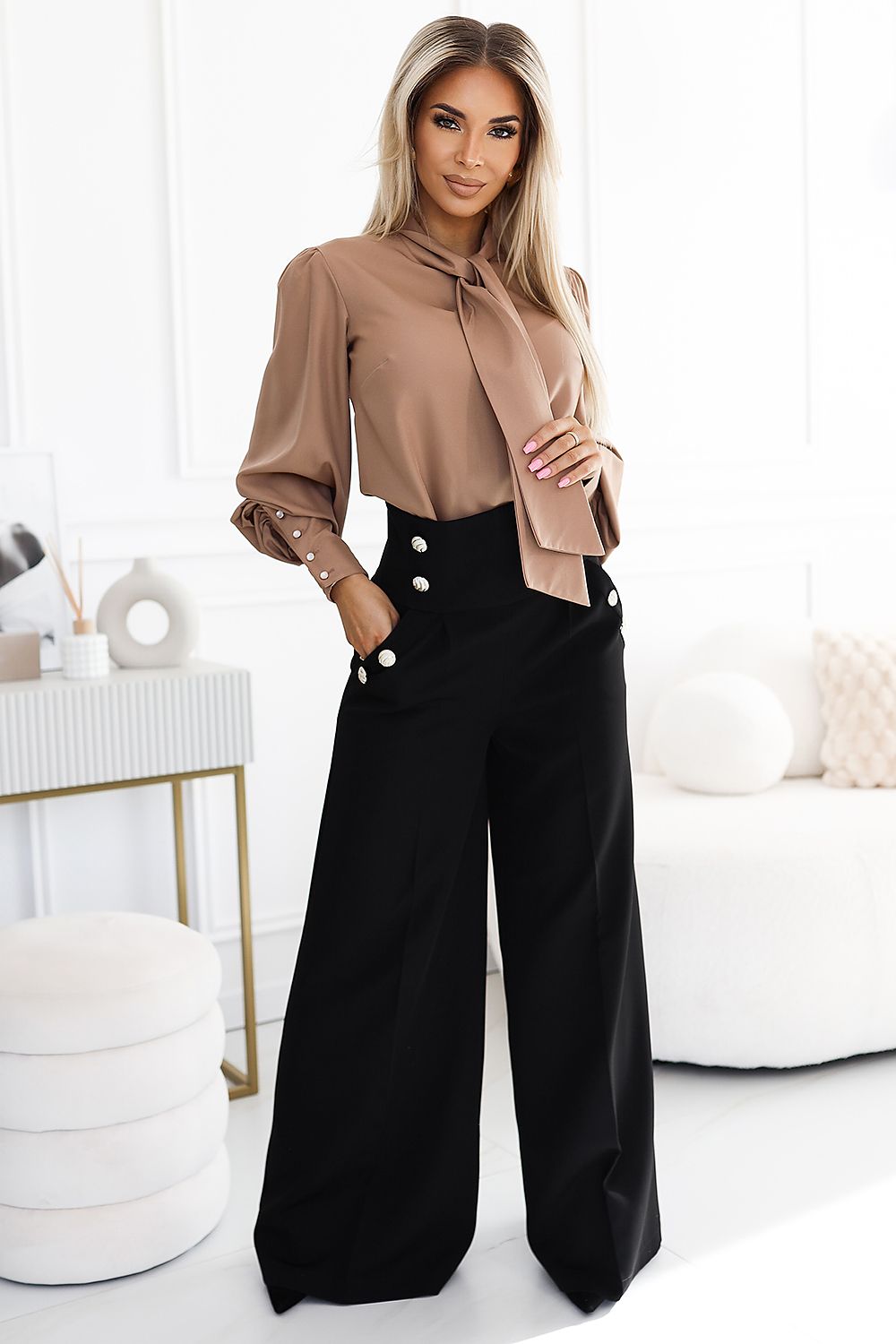 Elegant high-waisted trousers featuring decorative buttons, complemented by a sophisticated blouse, ideal for a luxurious fashion statement.
