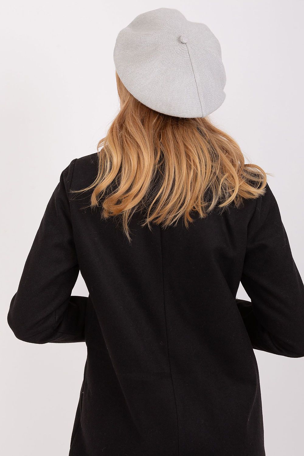 Elegant grey beret worn by a woman with long hair, showcasing a luxurious style perfect for winter fashion.