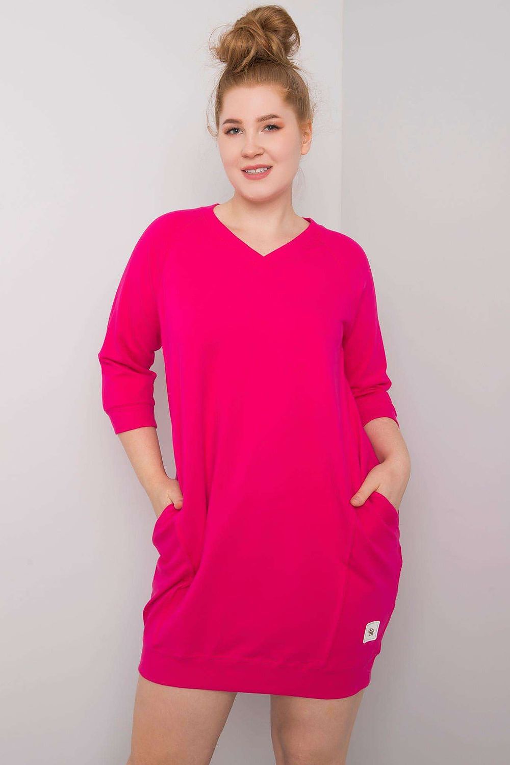 Luxurious Plus Size V-neck dress in vibrant pink, featuring a relaxed fit with three-quarter sleeves and convenient side pockets, perfect for effortless elegance.