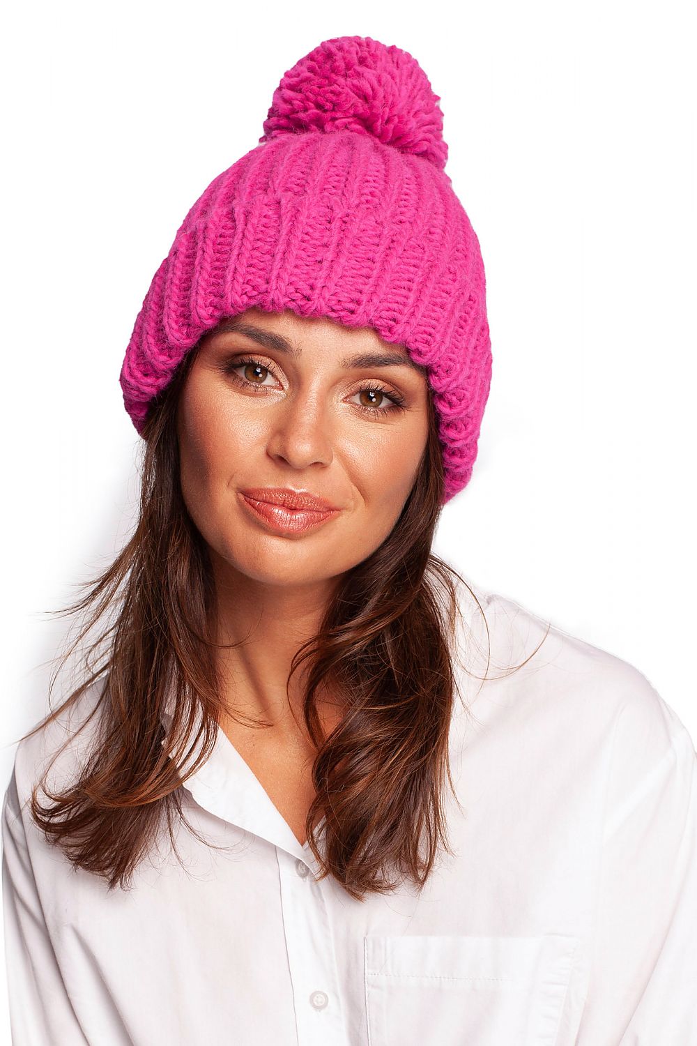 Elegant pink beanie with a fluffy pompom, showcasing luxurious knit design. Perfect for winter style. Beanies collection.