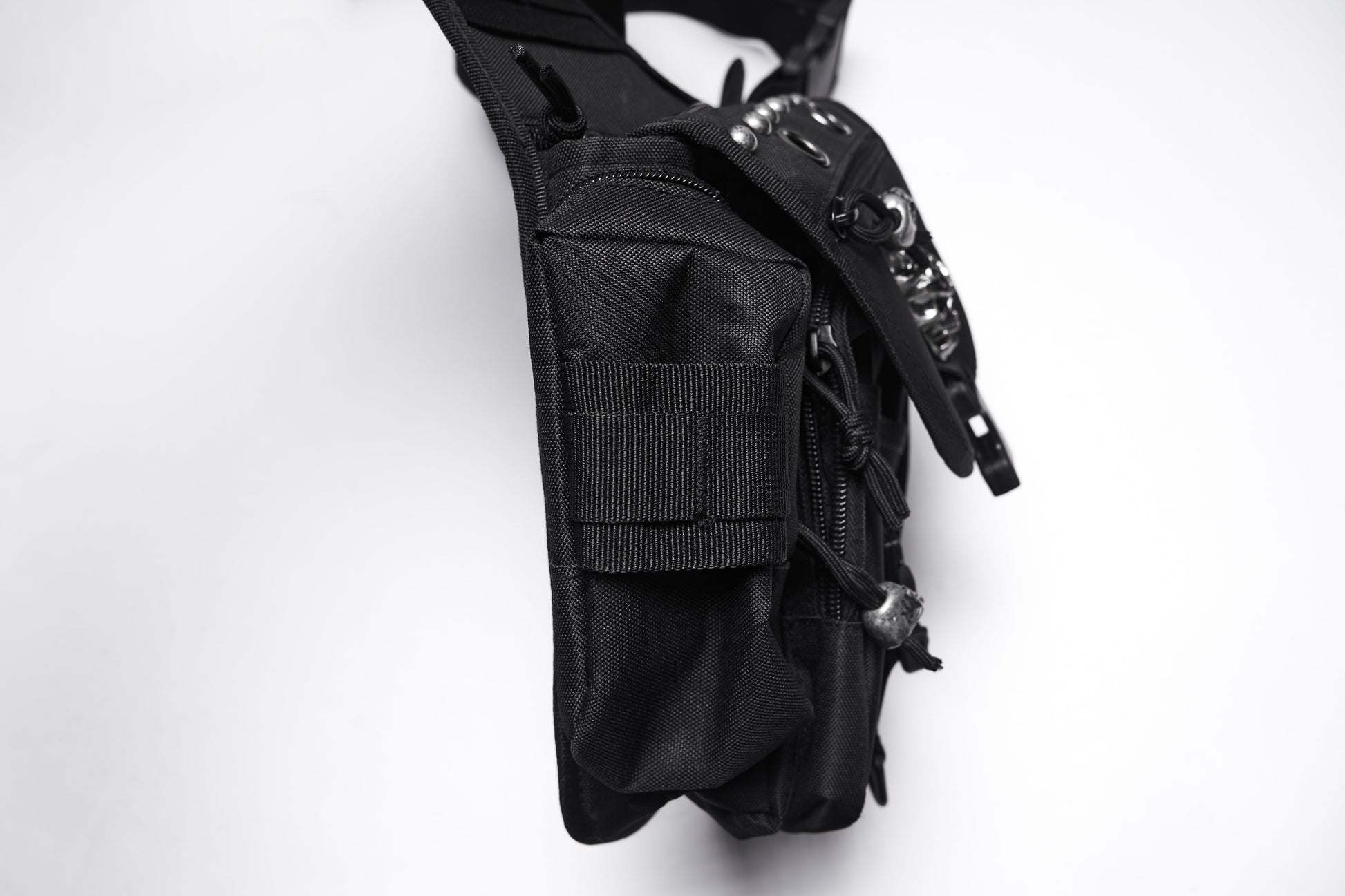 Close-up of the Punk Rave Tactical Goth Canvas Skull Waist-Leg Bag featuring heavy-duty rivets and a blend of punk aesthetics with practical storage, embodying luxury streetwear.