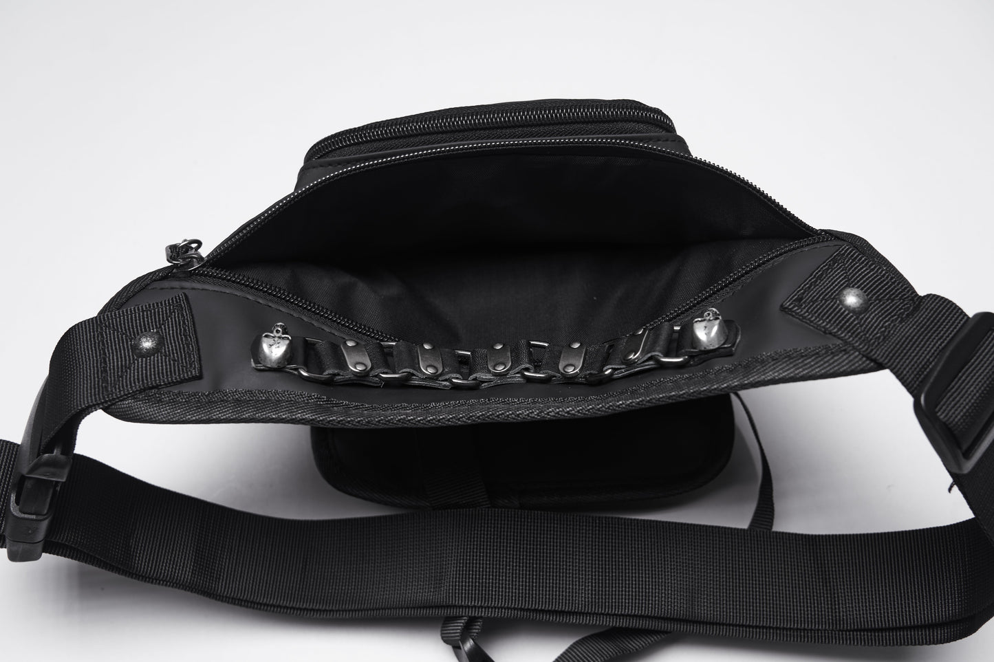 Elegant Punk Rave Cyberpunk Waist-Leg Bag showcasing intricate metal skull rivets and silver-tone chain detailing against a sleek black eco-friendly artificial leather backdrop.