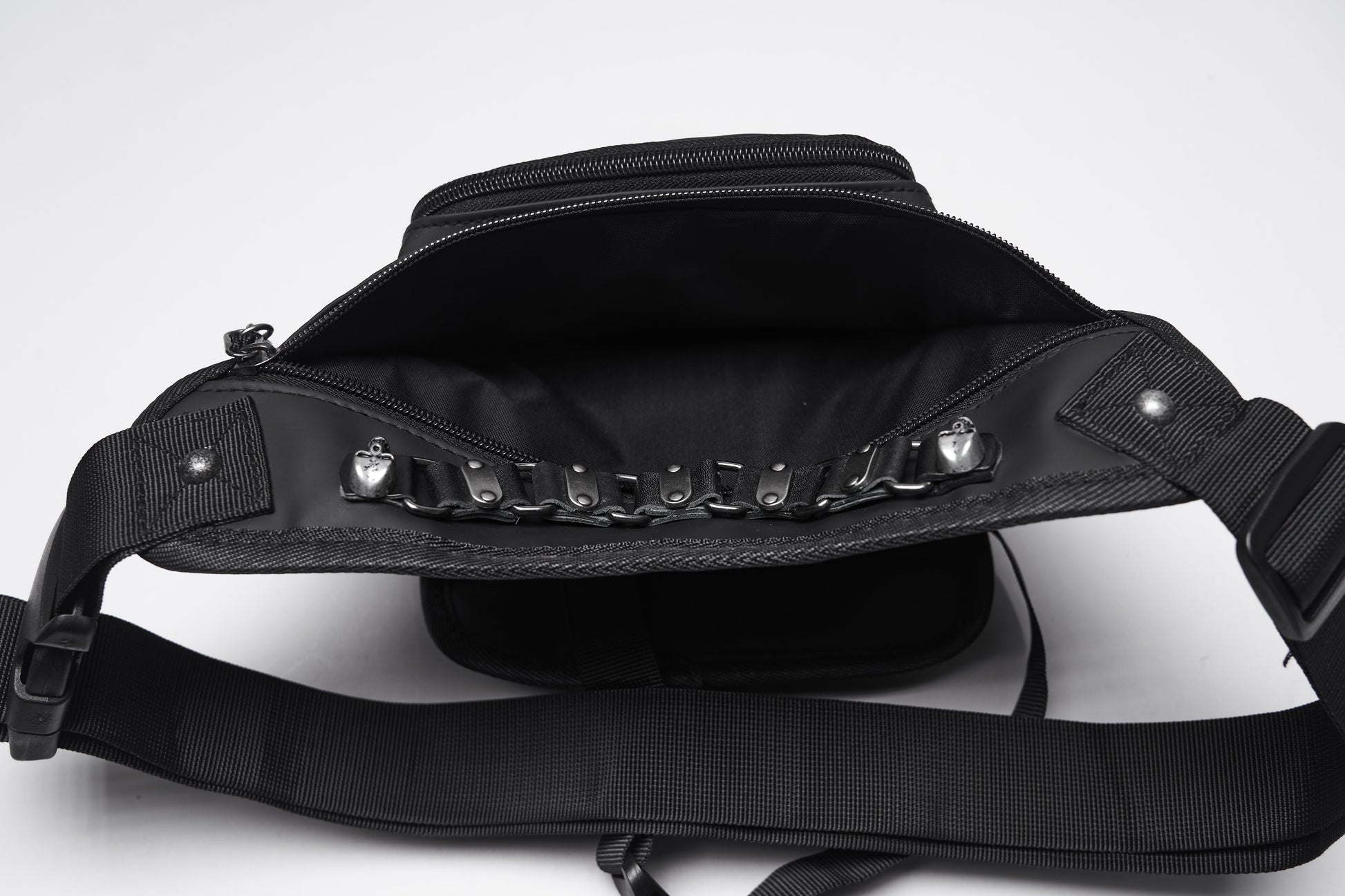Elegant Punk Rave Cyberpunk Waist-Leg Bag showcasing intricate metal skull rivets and silver-tone chain detailing against a sleek black eco-friendly artificial leather backdrop.