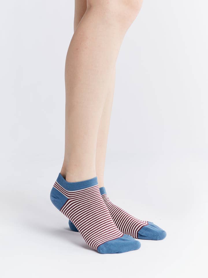 Luxury organic cotton trainer socks in a soft, comfortable texture with fine elastane cuffs, displayed in a stylish arrangement.