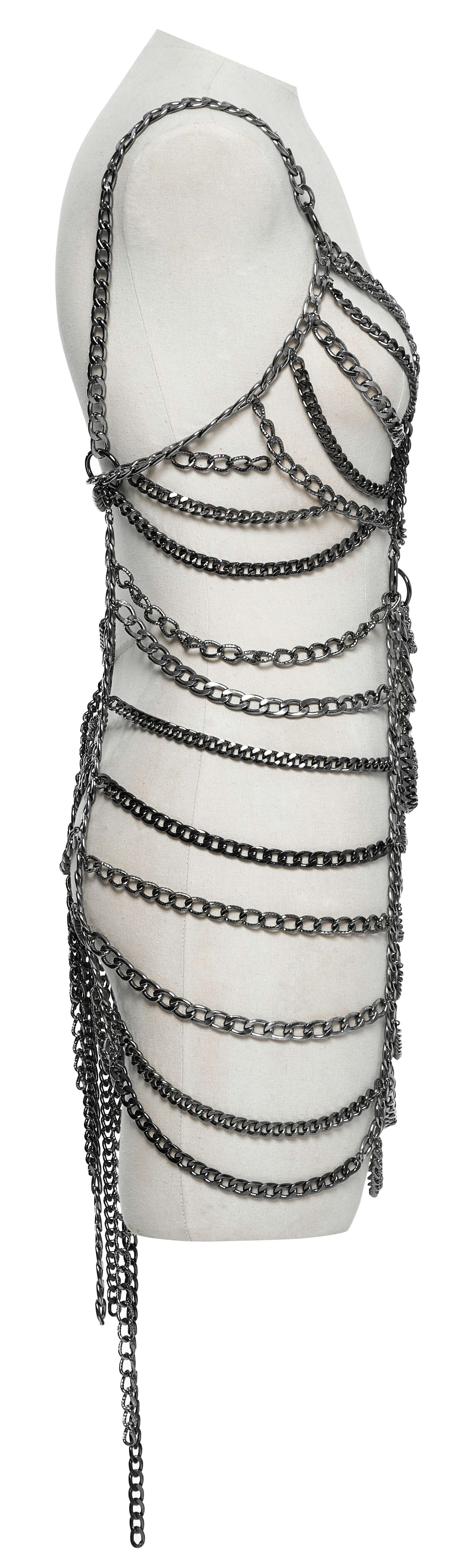 Stylish model wearing the Punk Rave Anslie Aluminium Chain Dress, elegantly layering it with contrasting garments for a chic look.