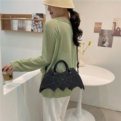 Chic view of a black Halloween Spider Web Shape Shoulder Bag worn casually, embodying the personality of the Batgirl aesthetic for trendy Halloween outings.