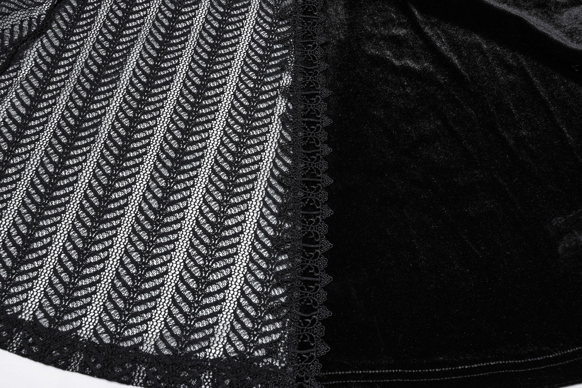 Flat lay of the Punk Rave Nera Goth Dynamic Skirt, emphasizing its luxurious fabric blend of velvet and lace, ideal for layering in winter outfits.