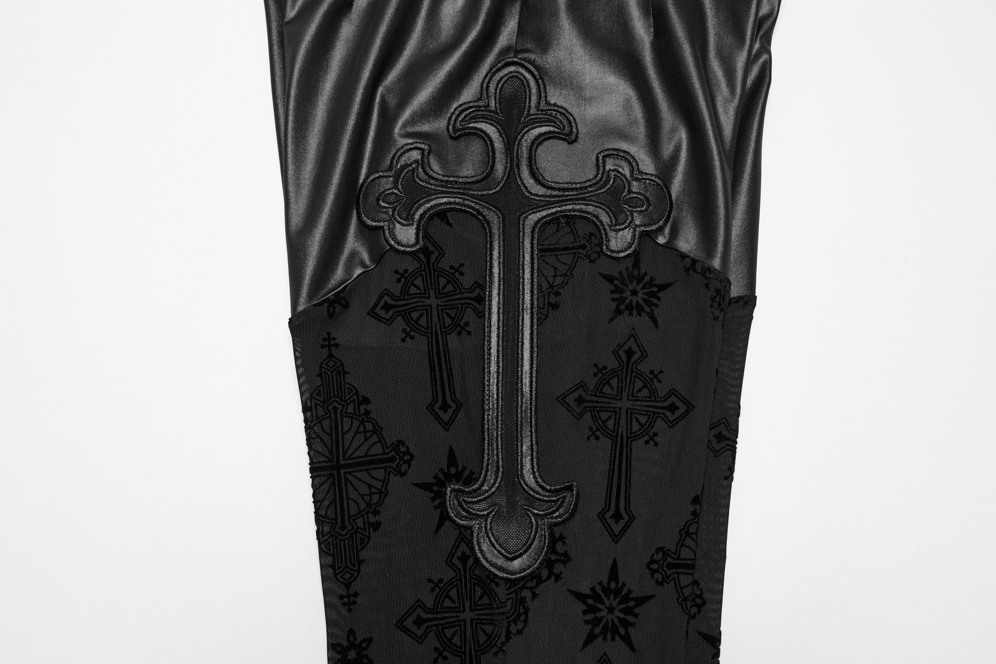 Flat lay of Gothic Punk Rave Seraphina Cross Flocking Flare Pants on a dark surface, emphasising the luxurious fabric and intricate details.