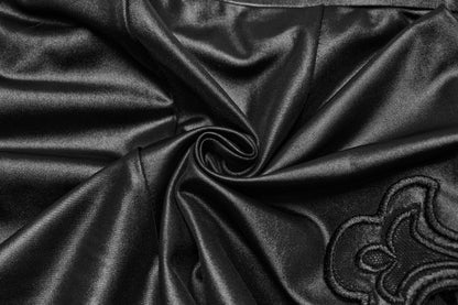 Close-up view of the alluring Punk Rave Seraphina Flare Pants, highlighting the detailed cross embroidery and the elegant blend of sheer and glossy textures, perfect for sophisticated goth aesthetics.