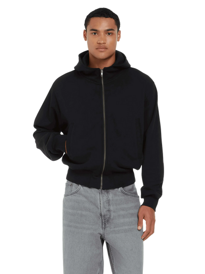 Close-up of premium organic cotton fabric on a stylish unisex bomber jacket hoodie, embodying eco-friendly fashion.