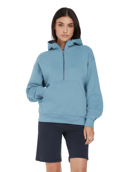 The women's organic cotton half zip hoodie in serene blue, perfect for sustainable fashion lovers seeking comfort and luxury.
