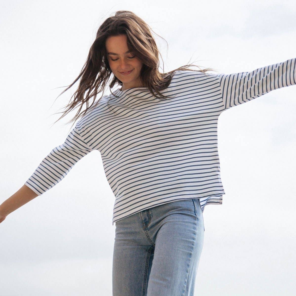 Luxurious organic cotton striped boat neck top with 3/4 sleeves, showcasing stylish Breton-inspired design, ideal for eco-conscious fashion enthusiasts.