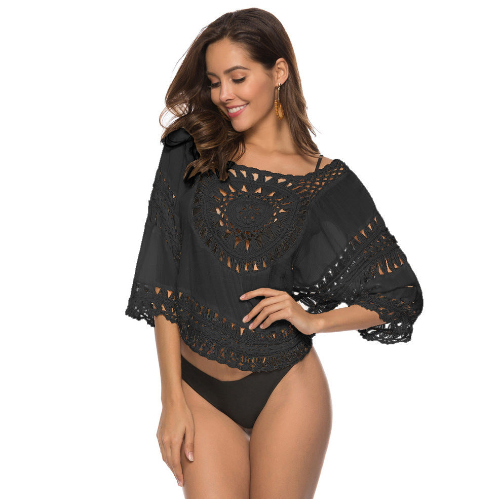 Sumptuous black lace cutout blouse, offering an elegant touch to any beachwear ensemble.