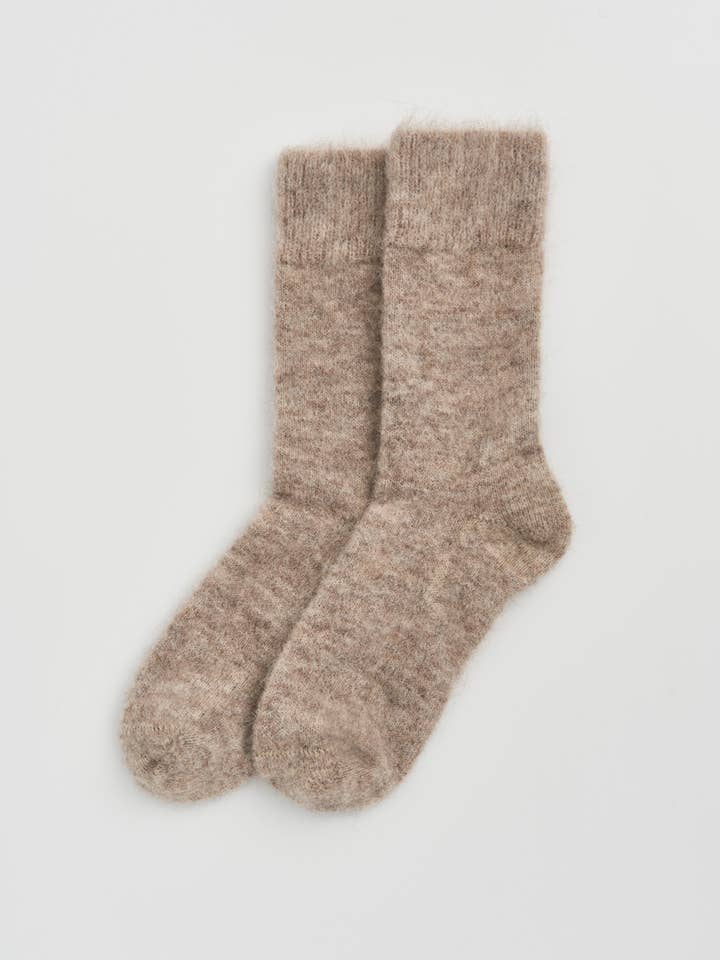 Luxurious ultra-soft alpaca bed socks in elegant display, showcasing their plush texture and cozy warmth, ideal for ultimate comfort at home.
