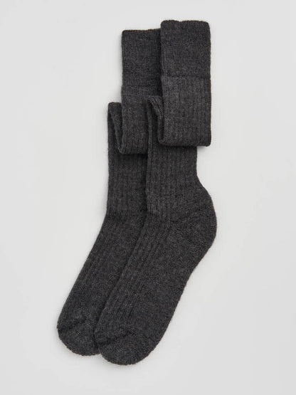 Elegant knee high wool socks made from premium materials, showcasing a cushioned sole for enhanced comfort and style.