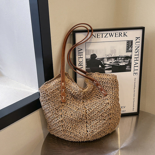 Elegant khaki straw handbag with faux leather shoulder strap, perfect for casual outings and travel.