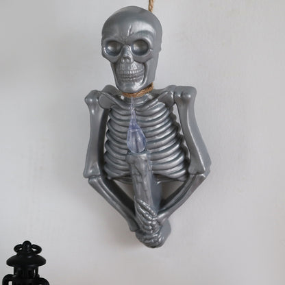 Halloween Decoration Skull Lamp Horror Atmosphere Arrange Hangings with a silver skeleton design holding a candle, ideal for creating an eerie ambiance.
