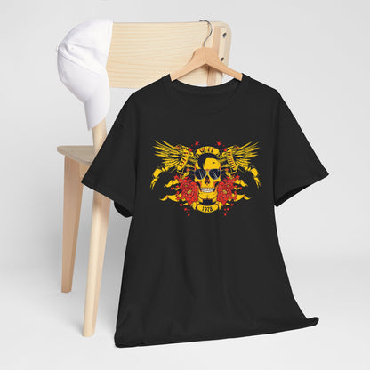 Chic black t-shirt draped on a wooden chair with a chic white cap, featuring a vibrant yellow skull and wings design, ideal for a contemporary luxury wardrobe.