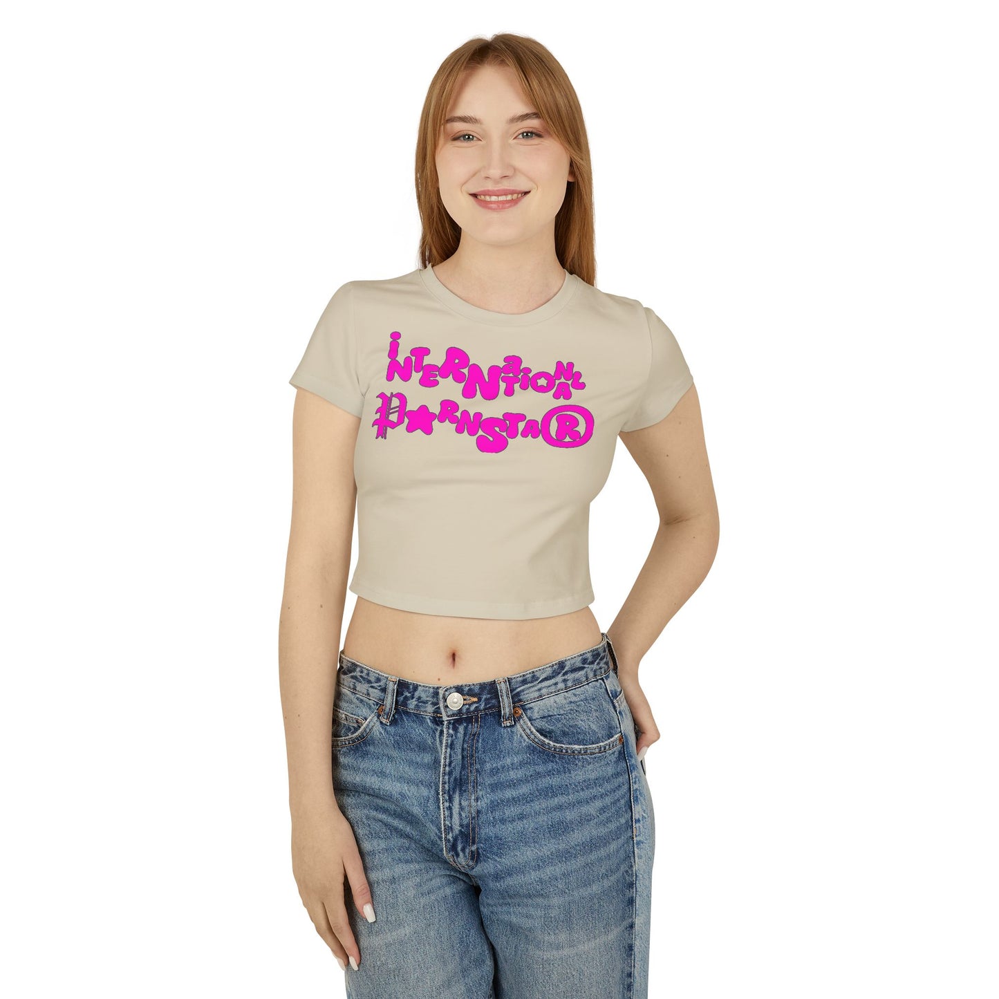 Sophisticated image of a woman wearing a beige crop t-shirt, featuring an eye-catching 'International Star' graphic in pink, exuding playful charm.