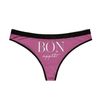 Sleek pink thong with black accents showcasing the whimsical phrase 'BON appétit', perfect for adding a humorous yet sophisticated flair to any lingerie collection.