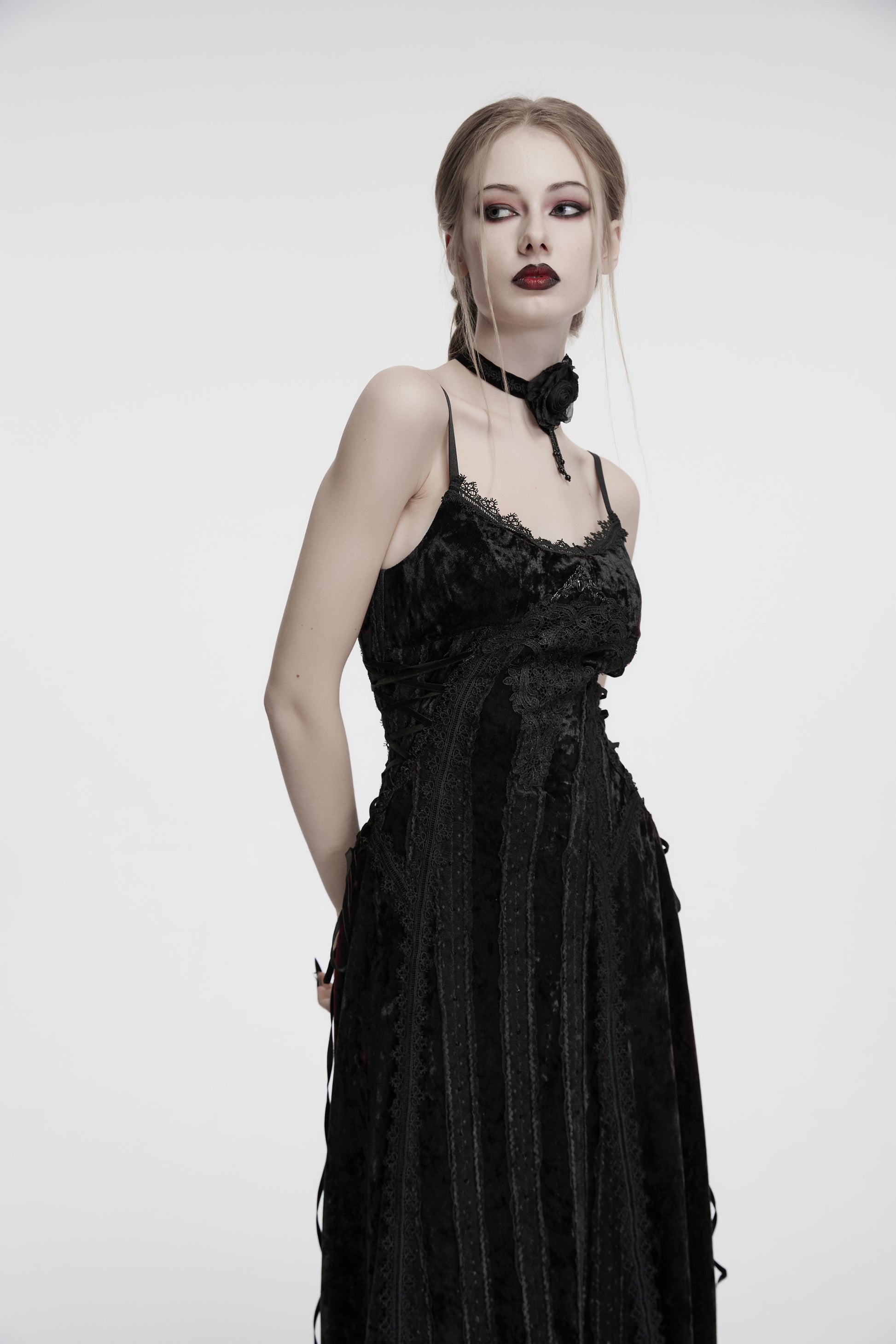 Stylish back view of the adjustable lace-up design of the black velvet goth dress, perfect for evening wear.
