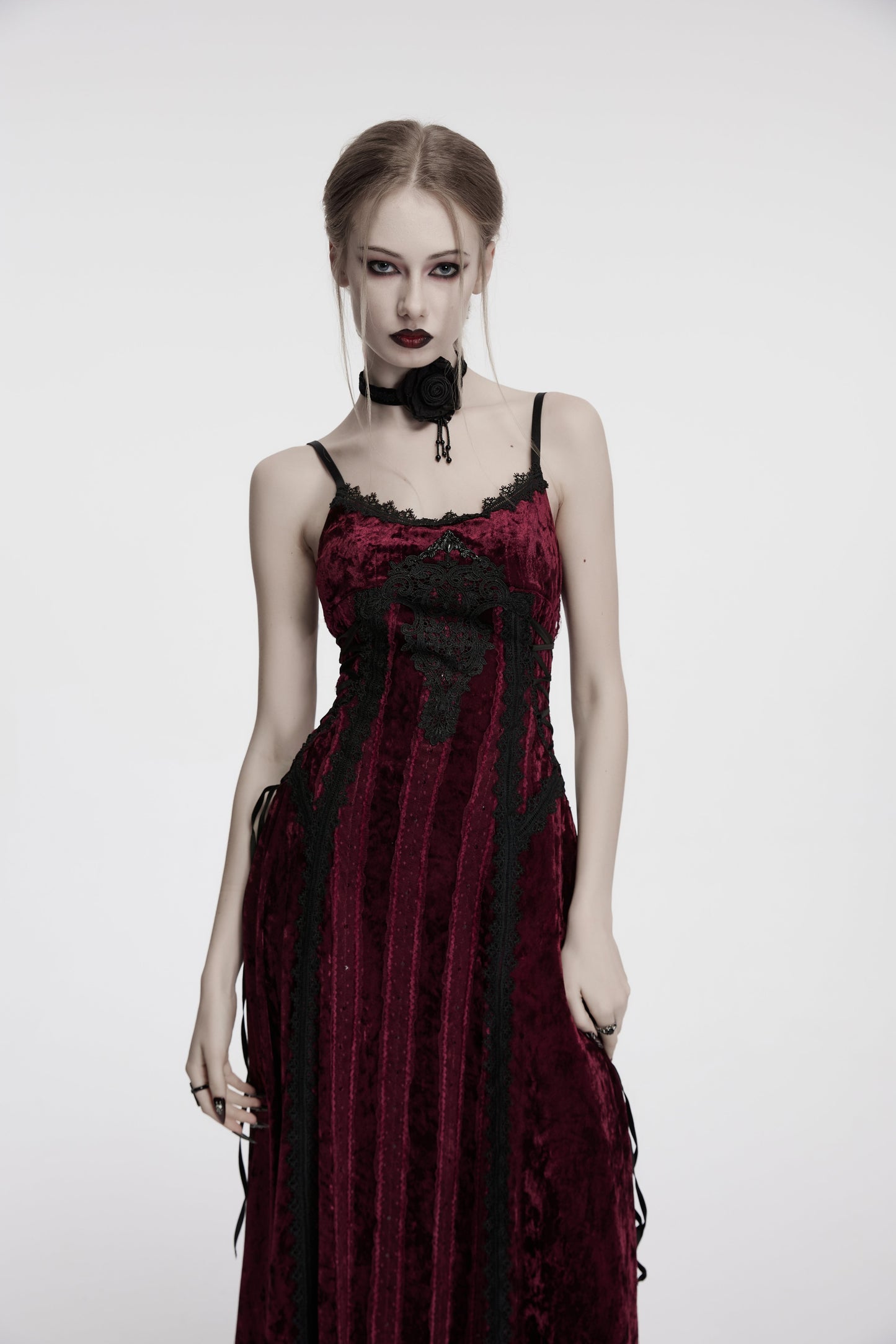 Model wearing the Punk Rave Vivienne Velvet Lace Panel Goth Slip Dress in Burgundy, styled for a romantic goth evening.