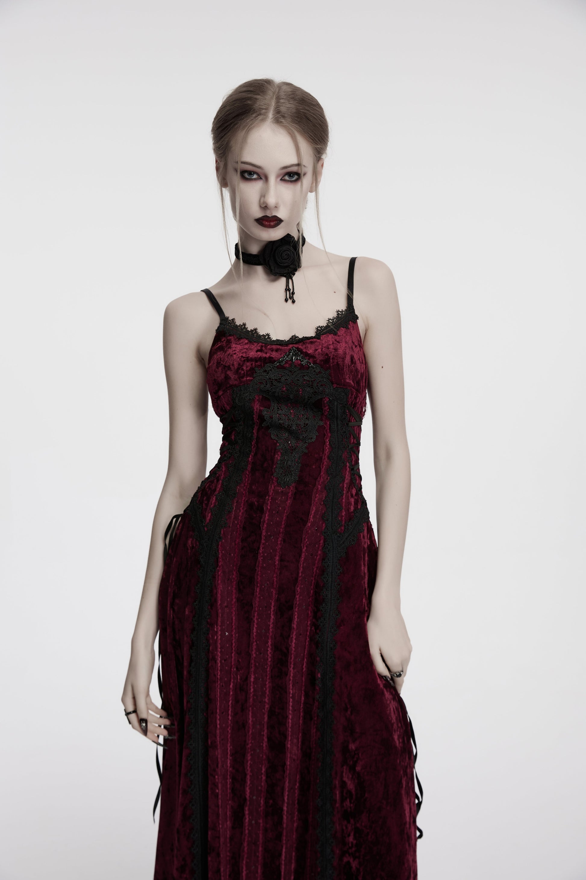 Model wearing the Punk Rave Vivienne Velvet Lace Panel Goth Slip Dress in Burgundy, styled for a romantic goth evening.