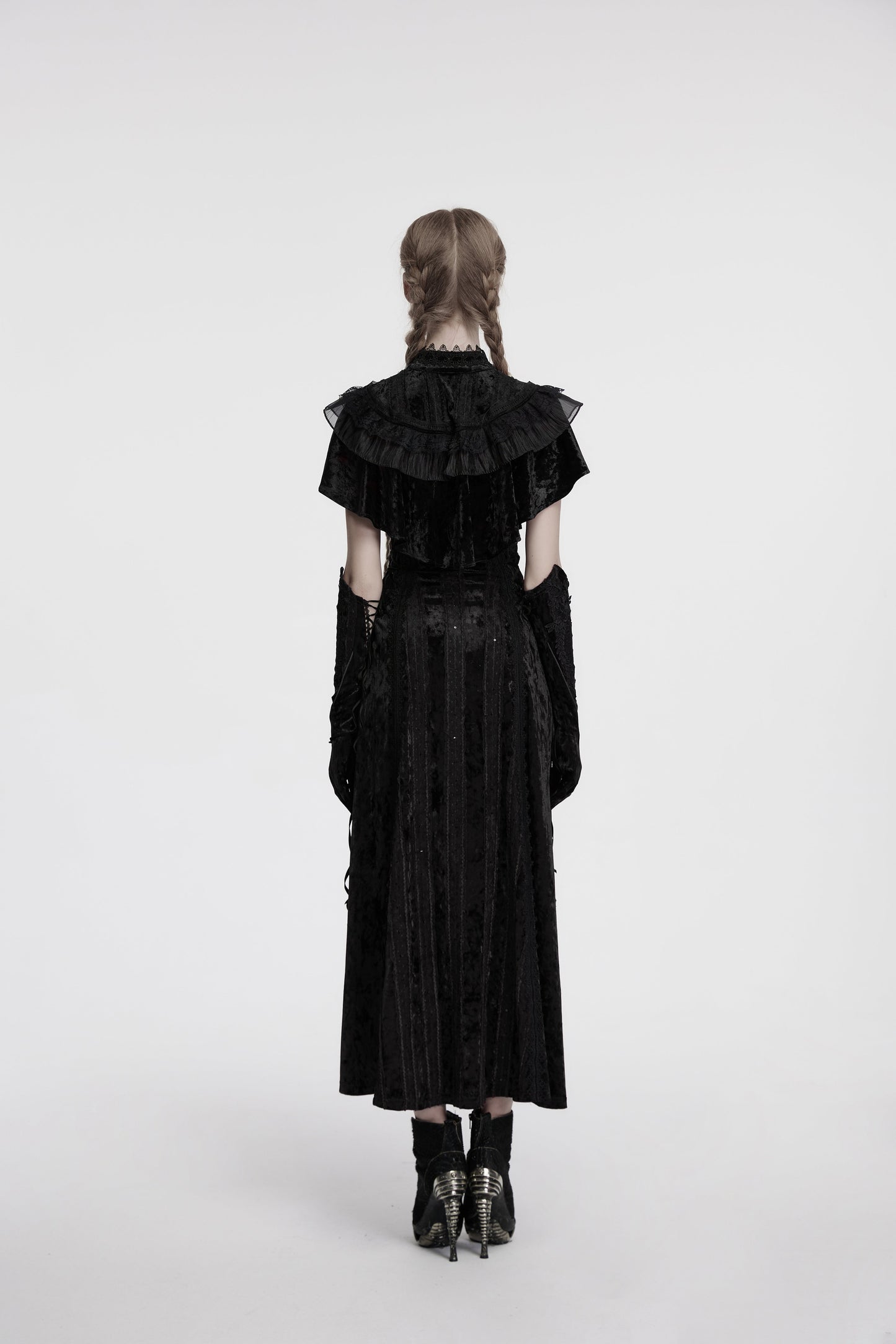 Full view of the Punk Rave Elysia black velvet shawl draped over a dress, showcasing its romantic silhouette and vintage rose buckle closure.