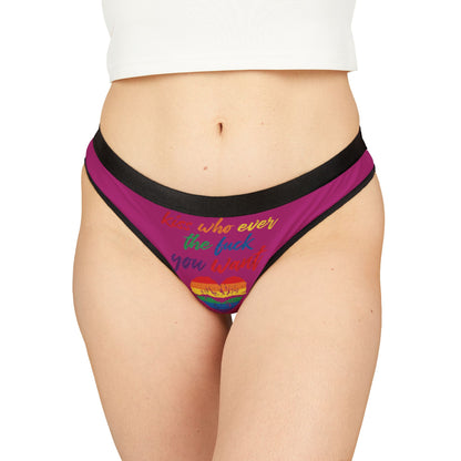 Luxurious women's thong with vibrant pink fabric featuring the playful slogan 'Kiss whoever the fuck you want,' adorned with a rainbow heart design, perfect for celebrating love and pride.