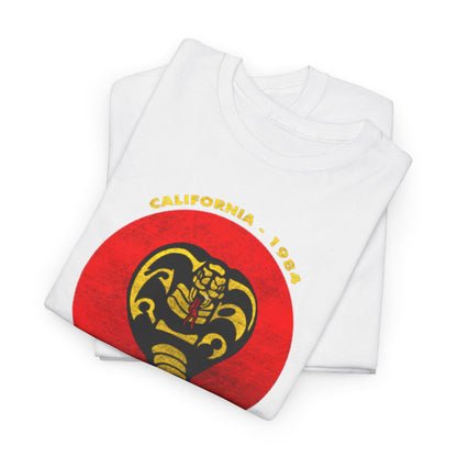 Chic display of folded white t-shirts adorned with the vintage Cobra Kai logo, perfect for fashion-forward martial arts fans. A blend of style and nostalgia, this highly sought-after design adds a touch of elegance to any wardrobe.
