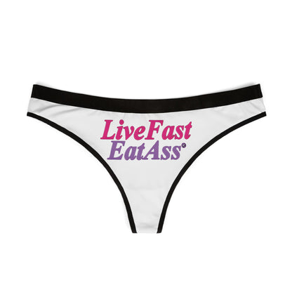 Stylish flat lay of the 'Live Fast Eat Ass' thong panties, highlighting the luxurious material and eye-catching typography, ideal for upscale lingerie collections.