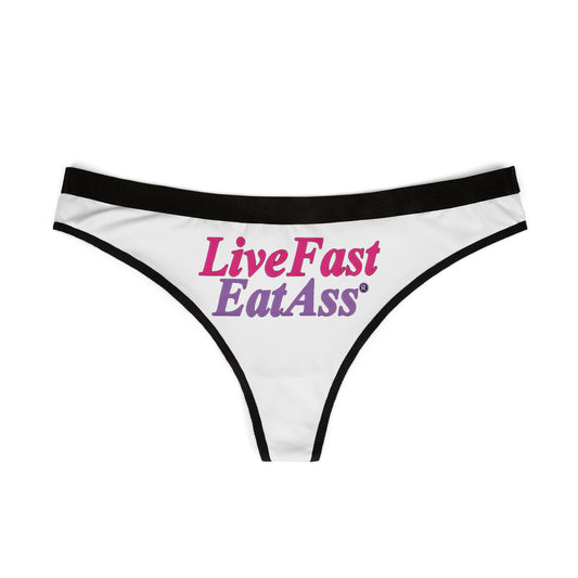 Stylish flat lay of the 'Live Fast Eat Ass' thong panties, highlighting the luxurious material and eye-catching typography, ideal for upscale lingerie collections.