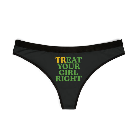 Elegant black women's thong displaying the humorous phrase 'TREAT YOUR GIRL RIGHT' in vibrant green and yellow text, perfect for adding a touch of fun to sophisticated lingerie.