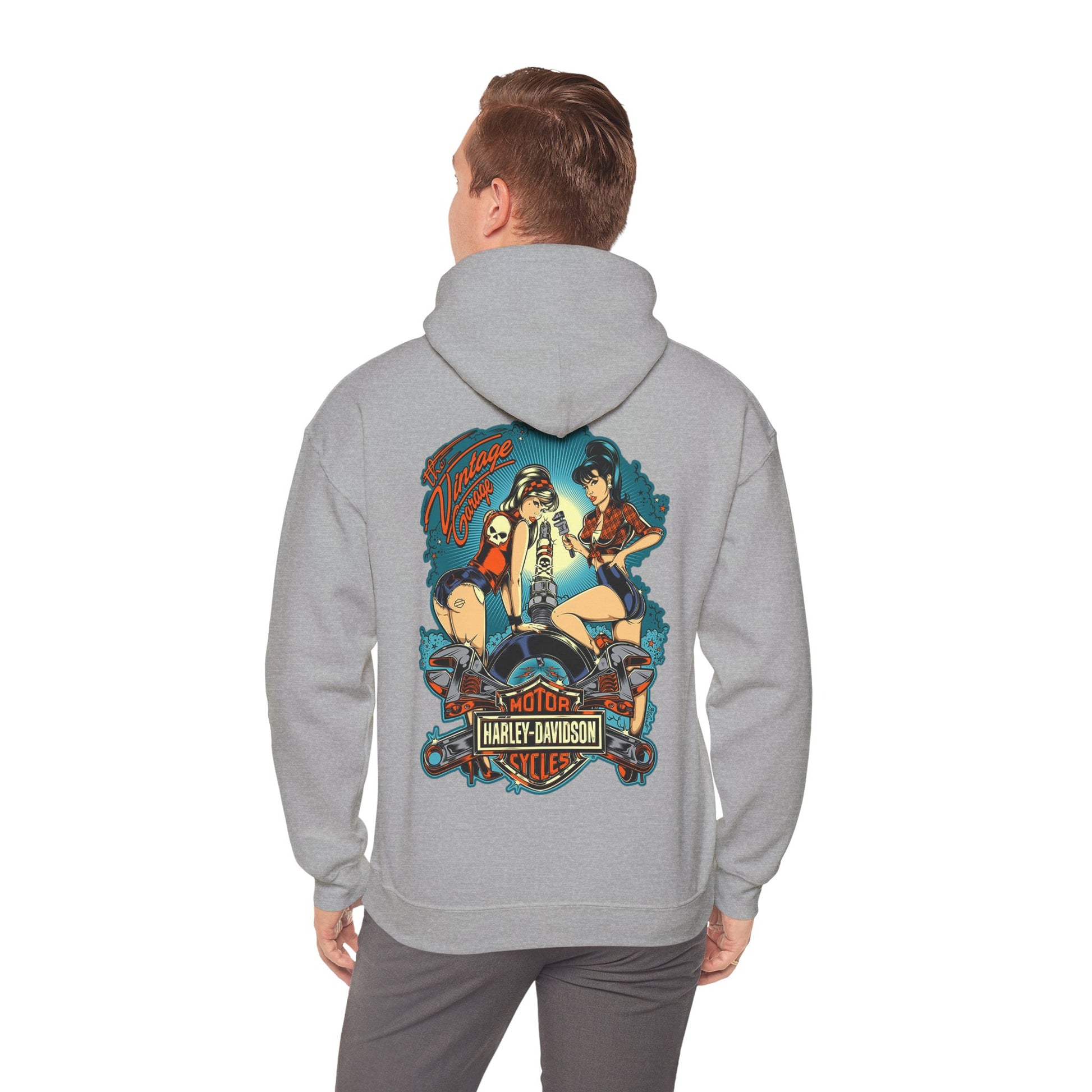 Chic grey hoodie worn by a male model, displaying a vibrant vintage back print featuring pin-up women and motorcycle motifs, exuding sophistication and edge.