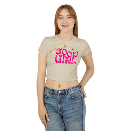 Elegant woman wearing the Cheeky Good Girl Cropped Tee in soft beige, showcasing the playful 'Good Girl' design with a dazzling pink font and halo motif, perfect for a stylish yet casual look.