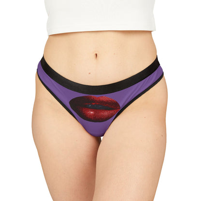 Luxurious women's thong featuring a bold graphic of glistening red lips set on a vivid purple background, designed for playful and romantic occasions.