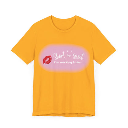 Front view of a chic unisex short sleeve tee in bright yellow featuring a playful lipstick print, inspired by Sabrina Carpenter, perfect for casual occasions.