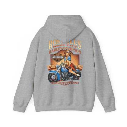 Sophisticated grey hoodie with a bold vintage illustration of a pin-up girl riding a blue motorcycle, enhanced by 'Boswell's Music City' and 'Harley-Davidson' branding, embodying a unique blend of comfort and luxury.
