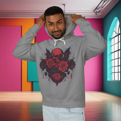 A stylish man pulling up the hood of the grey Unisex Lightweight Hooded Sweatshirt adorned with a unique designer skull and roses in a vibrant, modern space, showcasing a chic lifestyle.