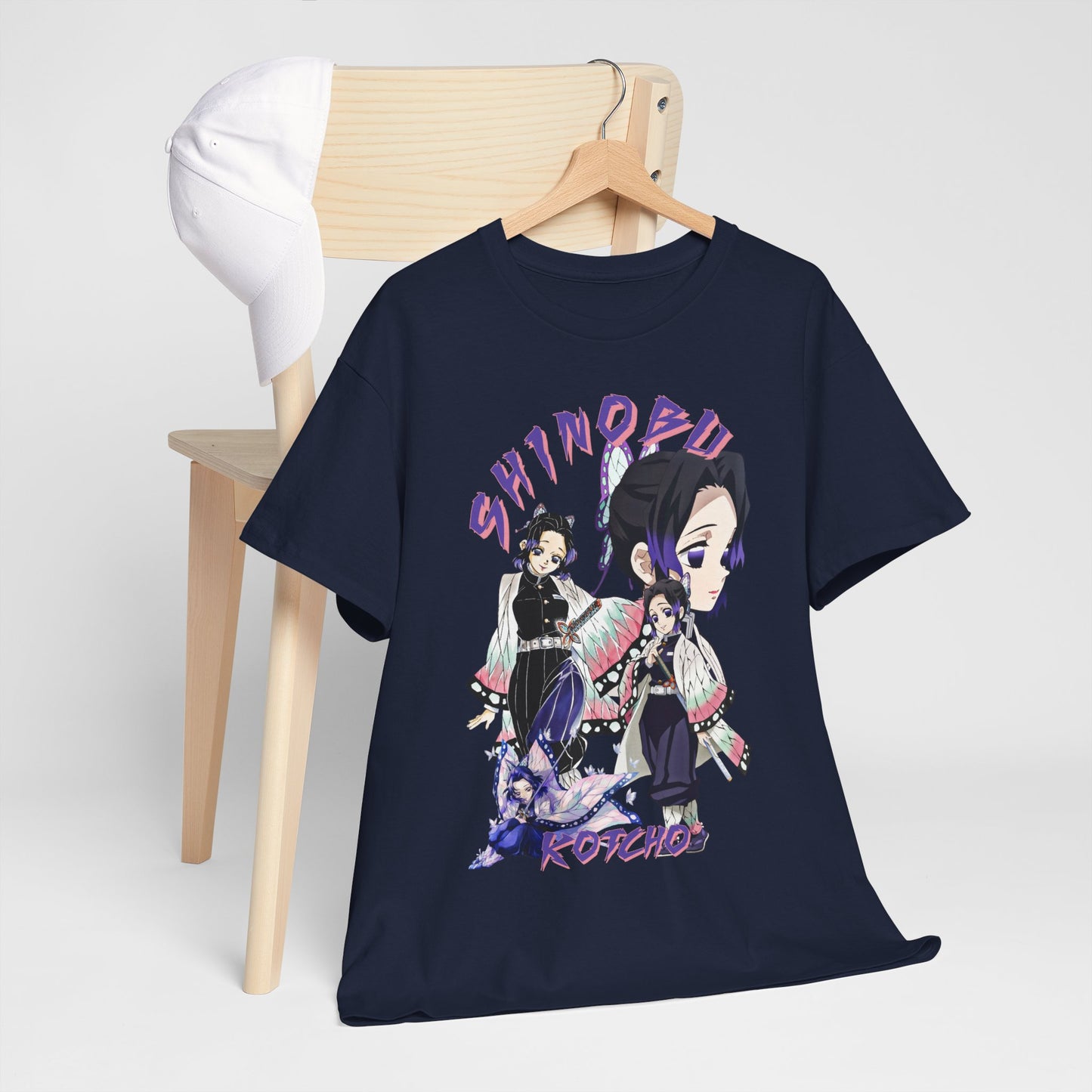 Elegant navy blue T-shirt styled on a hanger, showcasing stunning graphic design of Shinobu Kocho from Demon Slayer paired with a chic white cap, ideal for casual outfits and anime conventions.
